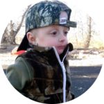 Young child wearing winter hat supported by Give Hope Nevada