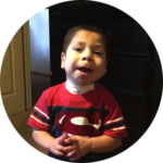 Young child smiling indoors supported by nonprofit